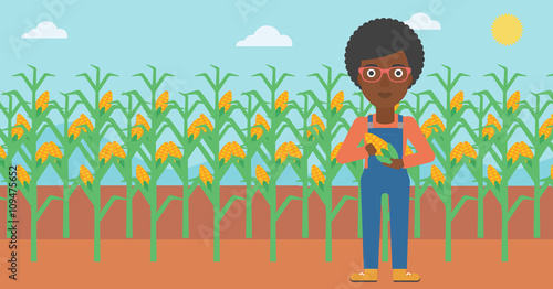 Farmer holding corn.