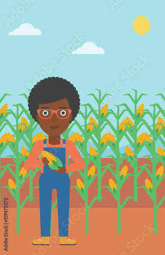 Farmer holding corn.