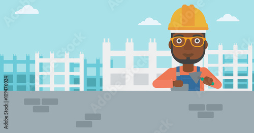 Bricklayer with spatula and brick.