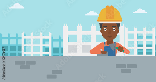 Bricklayer with spatula and brick.