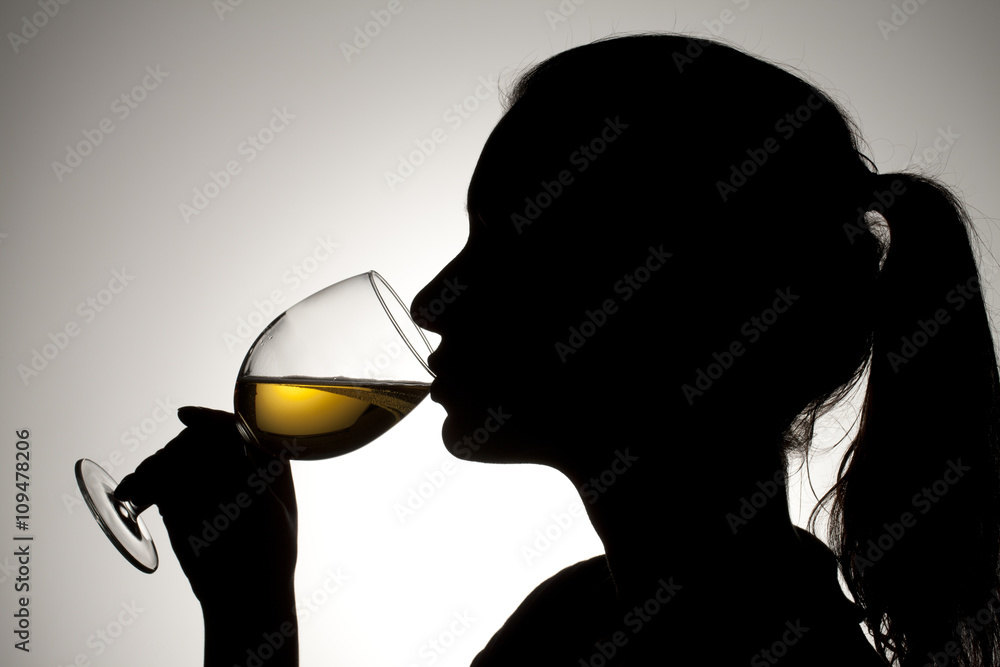 silhouette of a girl drinking wine.