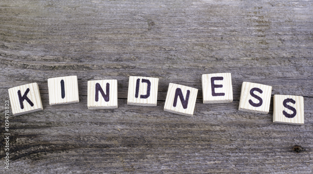 Fototapeta premium Text: Kindness from wooden letters on wooden background