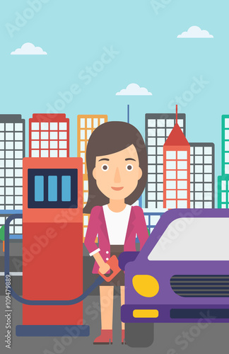 Woman filling up fuel into car.