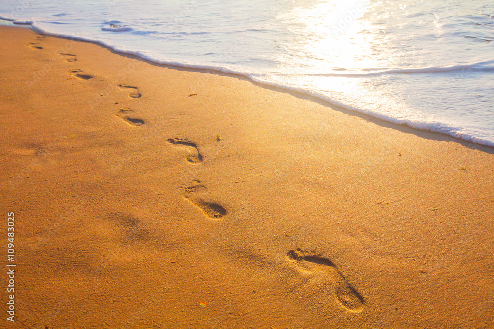 beach, wave and footprints at sunset time beach, wave and footprints at sunset time