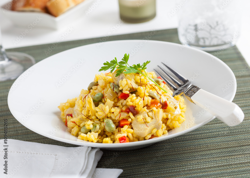 A plate of rice with vegetables and saffron. A plate of rice with vegetables and saffron.