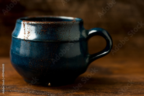 Coffee in grunge blue clay cup