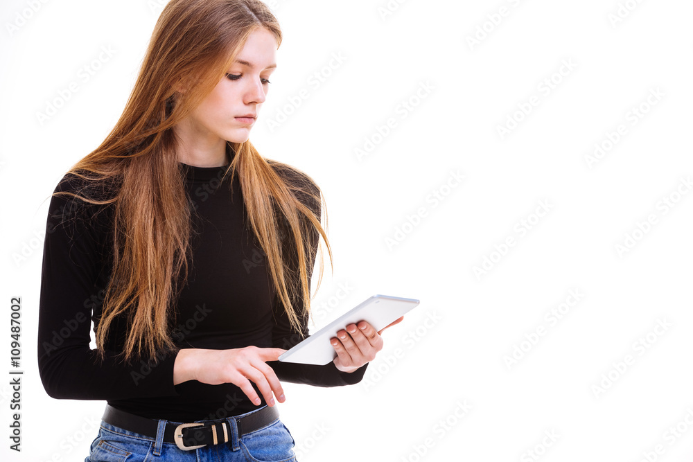 Beautiful young girl holding a tablet in the Studio. Beautiful young girl holding a tablet in the Studio.