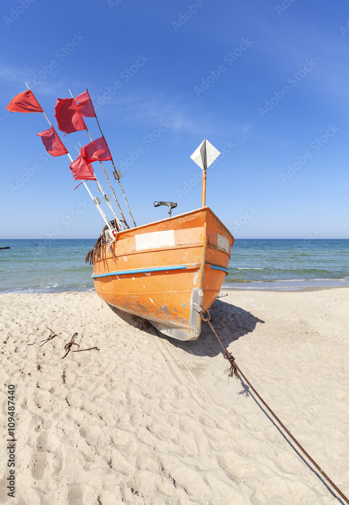Small fishing boat on a beach in Rewal, Poland. Small fishing boat on a beach in Rewal, Poland.