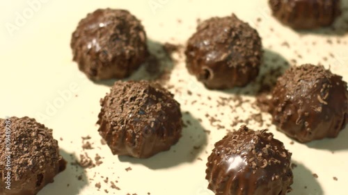 Wallpaper Mural Brown candies on beige background. Dark candies laying on cloth. Popular sweets with chocolate shavings. Dense and delicious. Torontodigital.ca