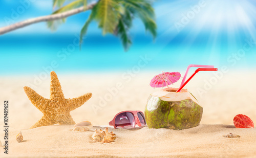summer coconut cocktail on tropical beach.