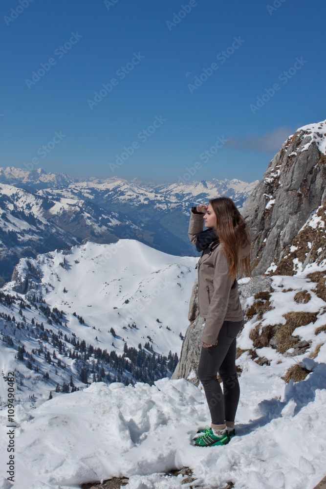 Beautiful girl in the high Swiss mountains. Holidays in the mountains. Welcome to Switzerland. The joy of youth.
