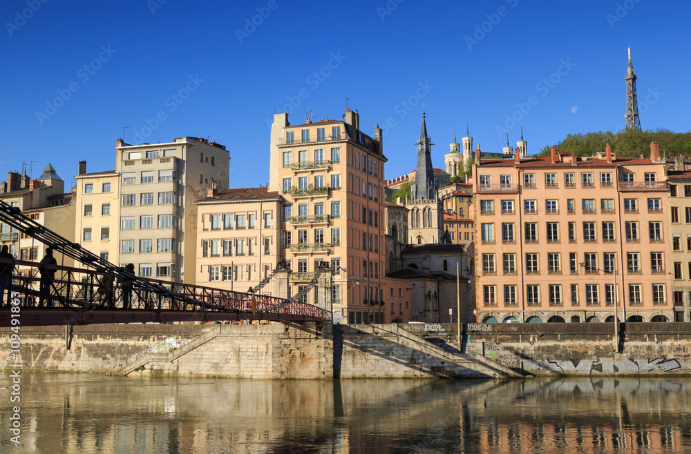 Pedestrians on the Passerelle Saint-Vincent over the Saone river in Lyon city.