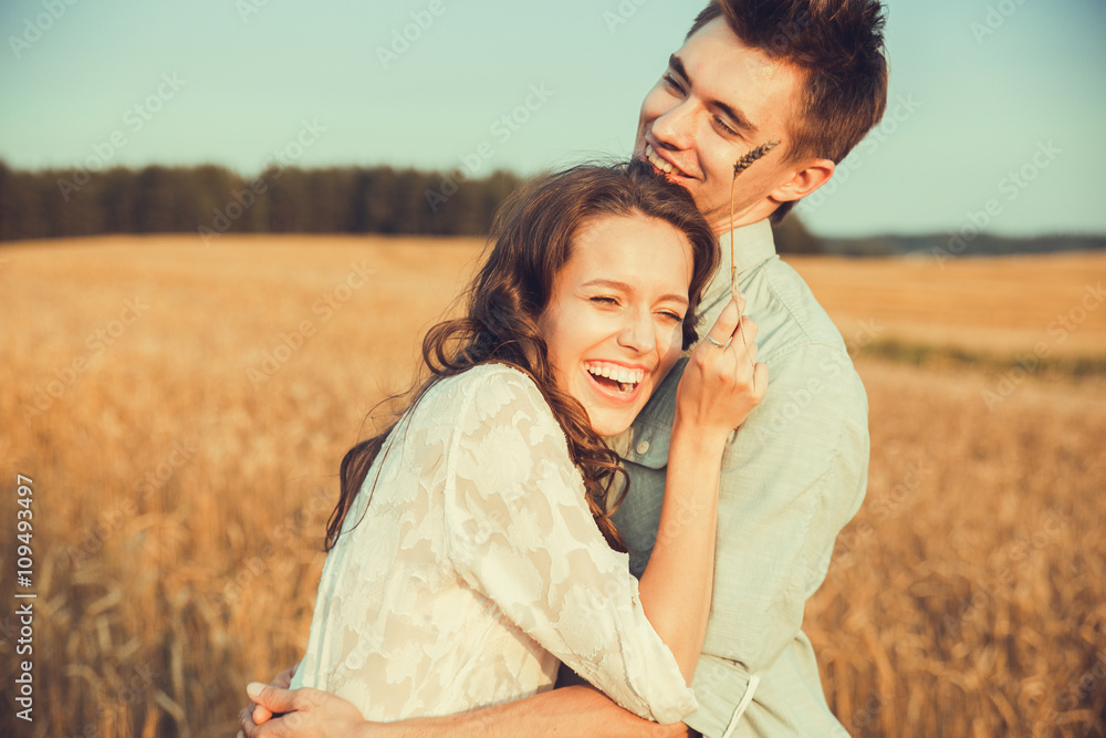 Young couple in love outdoor.Stunning sensual outdoor portrait of young stylish fashion couple posing in summer in field.Happy Smiling Couple in love.They are smiling and looking at each other Young couple in love outdoor.Stunning sensual outdoor portrait of young stylish fashion couple posing in summer in field.Happy Smiling Couple in love.They are smiling and looking at each other