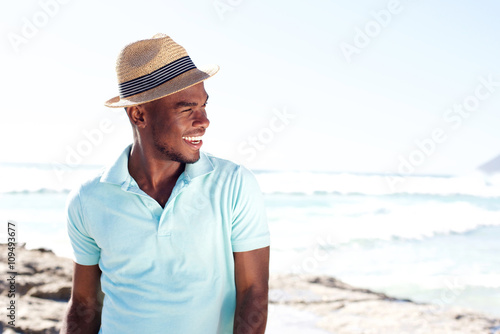 Stylish young african man at the beach