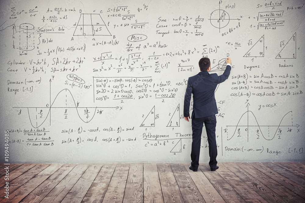 Man is writing solution of mathematical tasks on the wall Man is writing solution of mathematical tasks on the wall