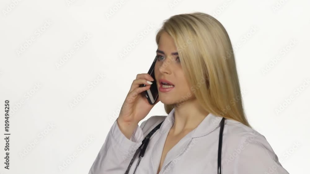 Doctor talking on the phone worried angry. White. Closeup Doctor talking on the phone worried angry. White. Closeup