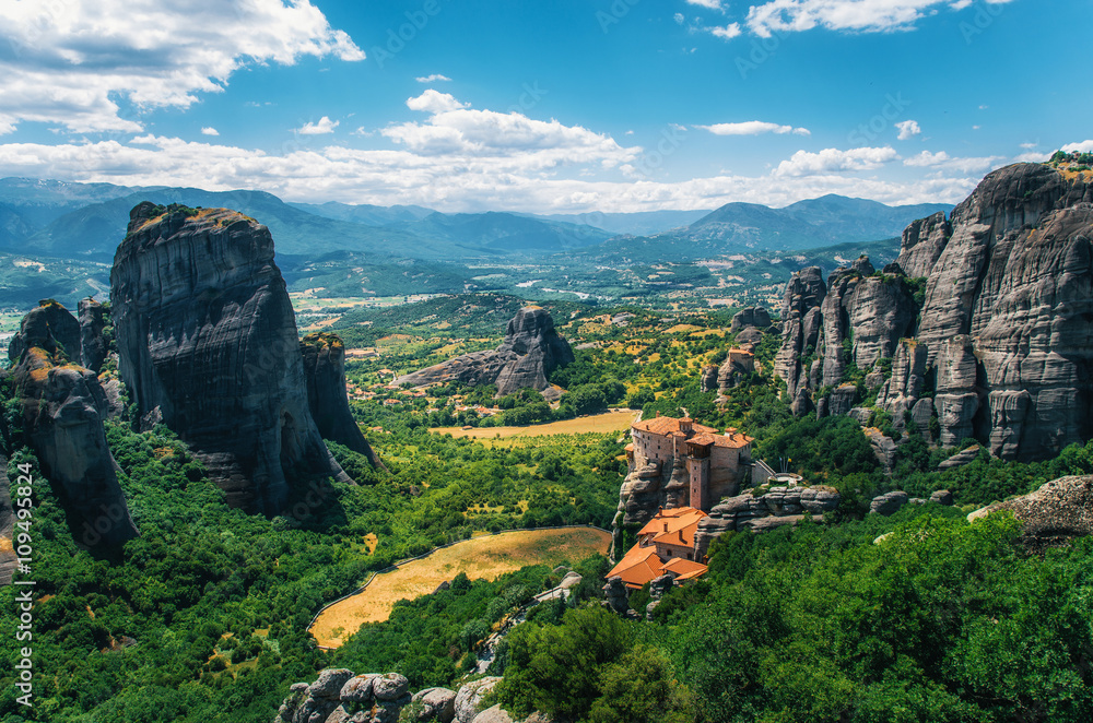 Obraz premium Meteora, Greece. Mountain scenery with Meteora rocks and Roussanou Monastery, landscape place of monasteries on the rocks, orthodox religious greek landmark in Thessaly