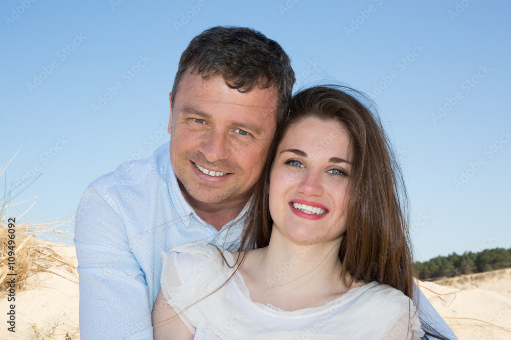 Happy and smiling couple posing and looking to the camera Happy and smiling couple posing and looking to the camera