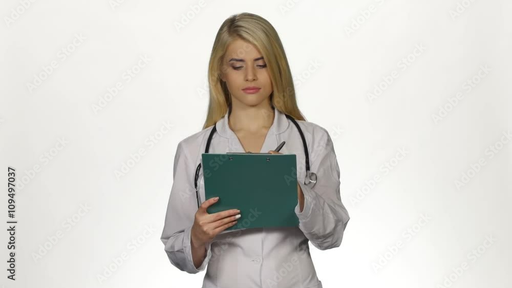 Health worker takes notes on clipboard. White Health worker takes notes on clipboard. White