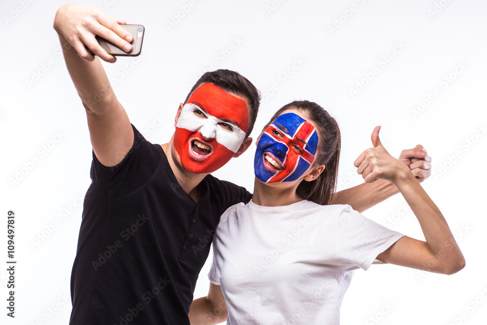 Iceland vs Austria football fans take selfie photo with phone on white background. European football fans concept. Iceland vs Austria football fans take selfie photo with phone on white background. European football fans concept.
