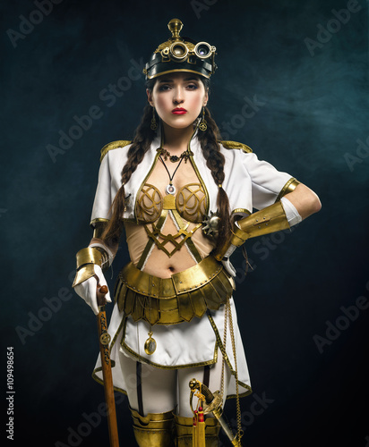Portrait of a beautiful steampunk girl with walking stick and sa