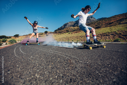 Photography Young people longboarding down the road