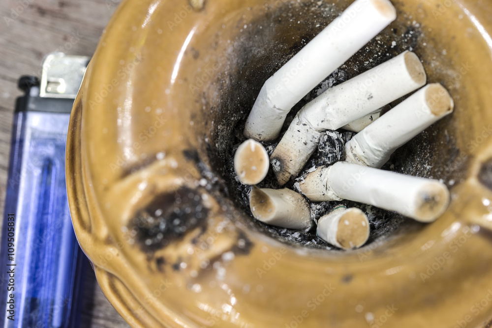 Close up cigarette butts stuck in ash, stop smoking and smoking addiction concept Close up cigarette butts stuck in ash, stop smoking and smoking addiction concept