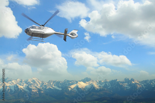 Helicopter in flight over a panoramic view of Tatra mountains