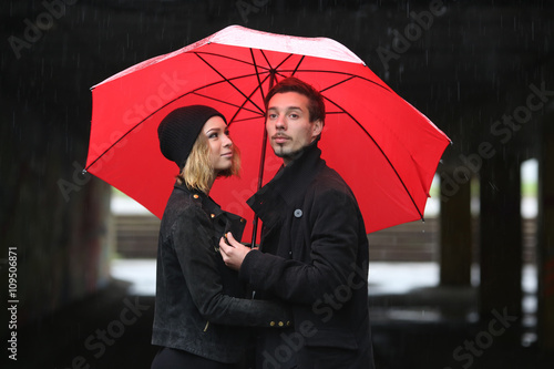 love young people under the red umbrella