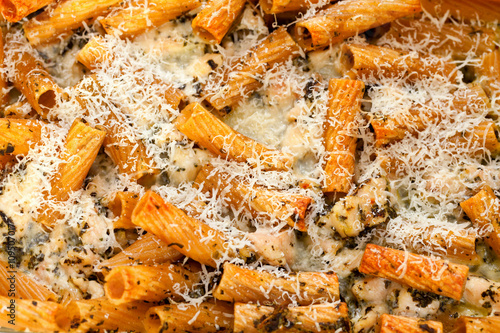 Baked Penne pasta with parmesan cheese. Shot from above. Close up, horizontal shot