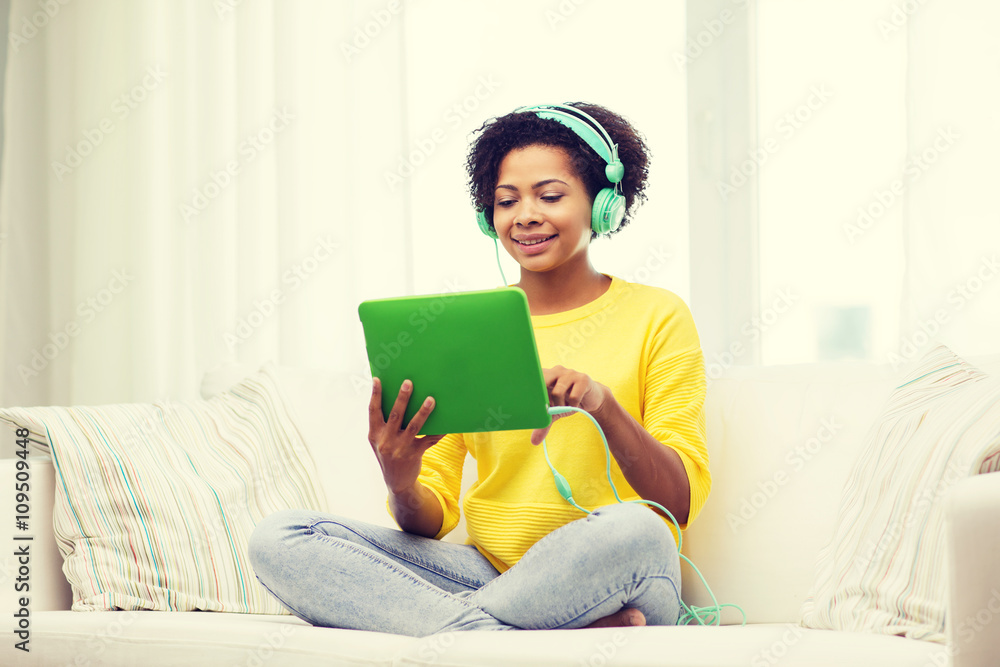 happy african woman with tablet pc and headphones happy african woman with tablet pc and headphones