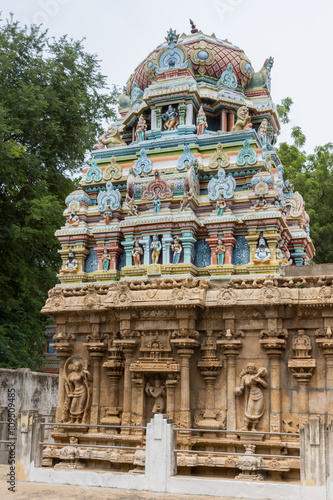 Trichy, India - October 15, 2013: Colorful short Vimanam on top of older temple building at Ranganathar Temple  built during Madurai Nayak era. Statues on wall of sandstone base. photo