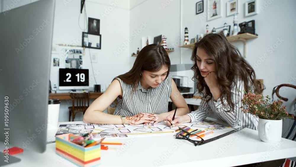 Two women working together at an architect office Two women working together at an architect office