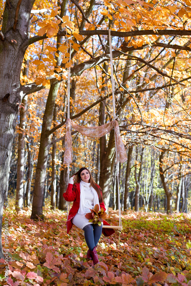 an expectant mother goes for a walk in the autumn park of swing an expectant mother goes for a walk in the autumn park of swing