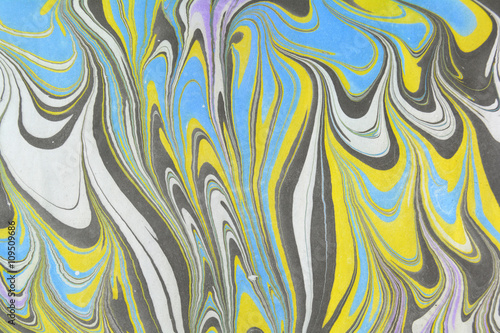Ebru art. Traditional Turkish Ebru technique. Painting on water transferred on highly textured paper or cloth. Color paint ebru with waves and tile pattern.