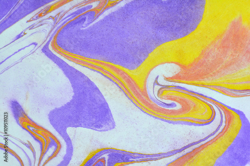 Abstract background. Ink marbling texture. Blue, yellow, red and white. Hand drawn marble illustration, ebru aqua paper and silk print. Traditional Turkish ebru technique. Painting on water. 