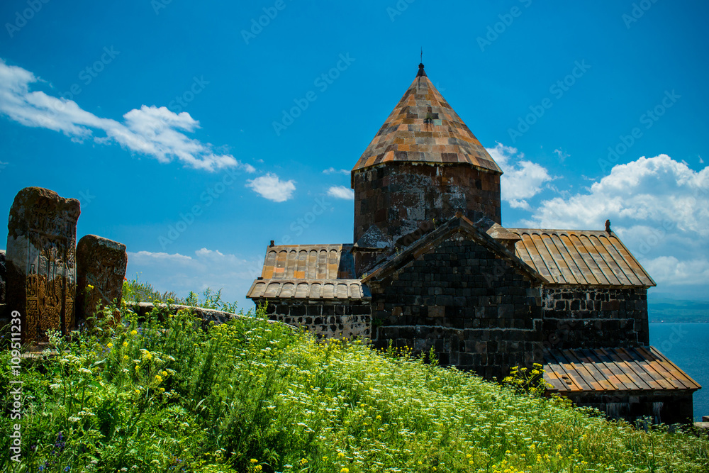 Landscape with church, Khachkars and grass