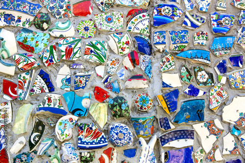 wall with broken ceramic plates colored fragments