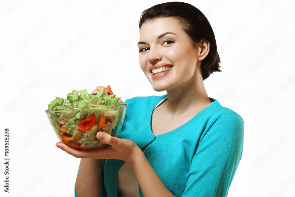 Beautiful girl holding a bowl of salad in her hands. Healthy eat Beautiful girl holding a bowl of salad in her hands. Healthy eat