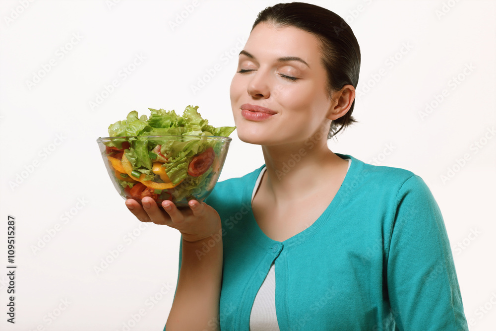 Beautiful girl holding a plate with a delicious salad in the han Beautiful girl holding a plate with a delicious salad in the han