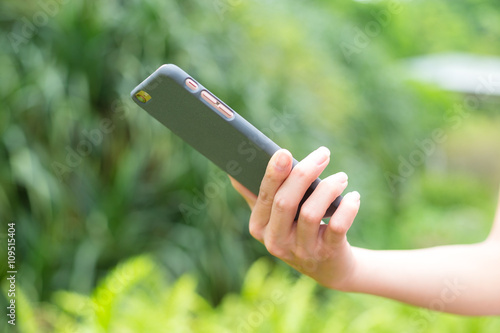 Young woman using cellphone outdoor