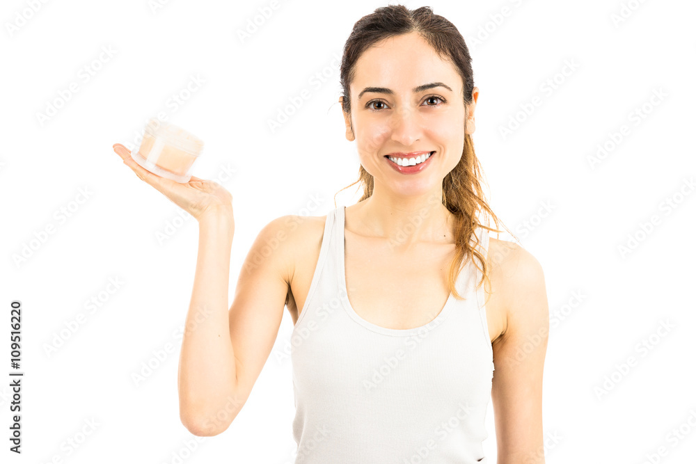 Attractive caucasian woman holding a cream bottle Attractive caucasian woman holding a cream bottle