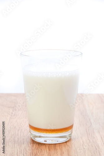hot milk with honey on white background..