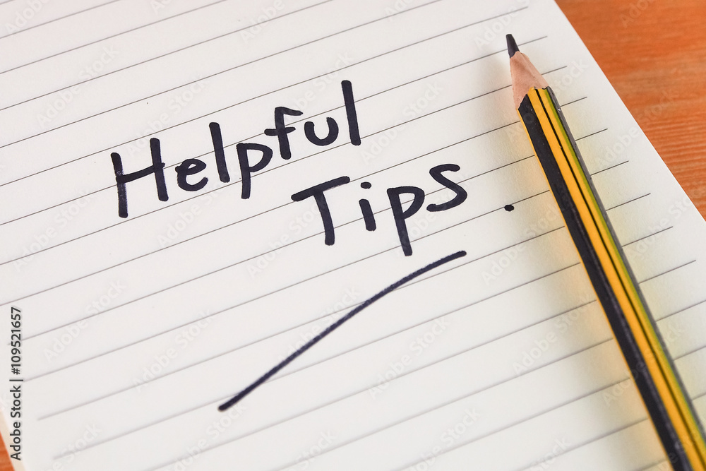 handwriting word helpful tips on note paper with pen wooden desk background handwriting word helpful tips on note paper with pen wooden desk background