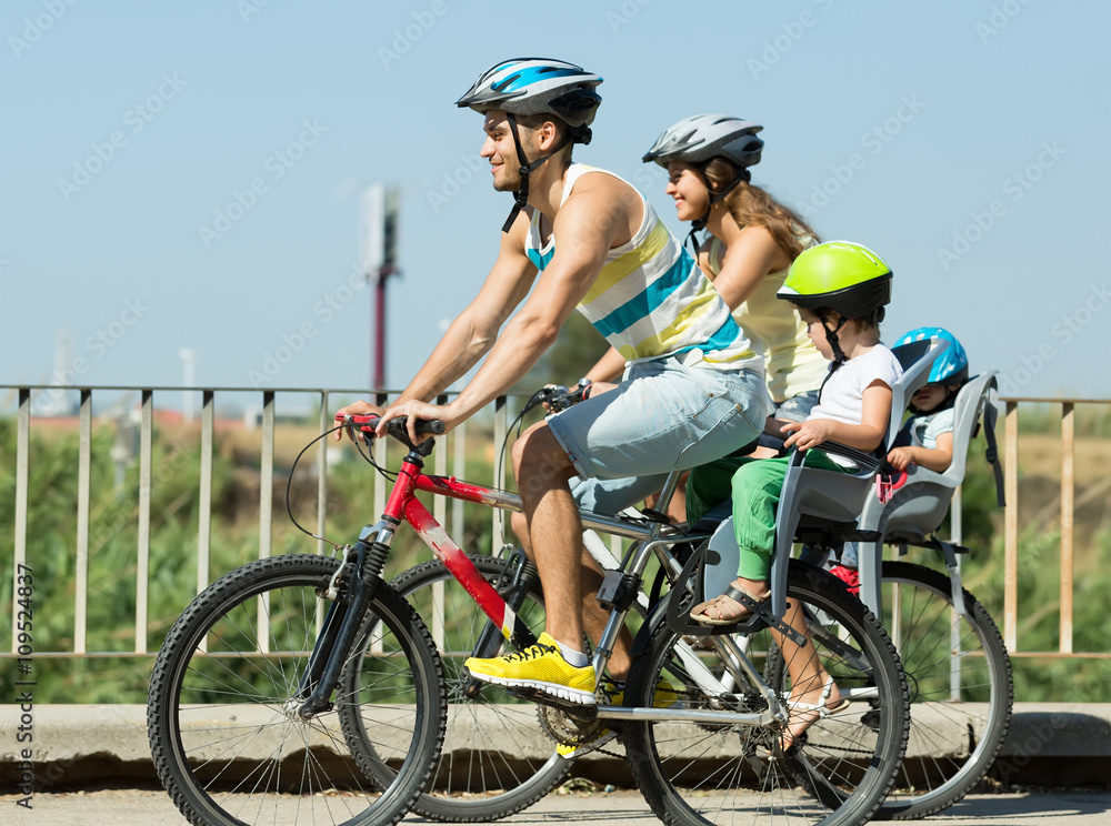 Family of four traveling by bicycles