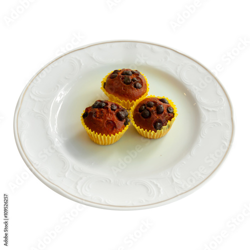 Chocolate & blueberry muffins in paper cases in white plate