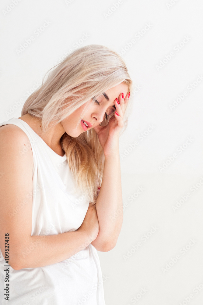 Tired ill woman with headache and flu. Unhealthy sad disappointed girl. Family conflict, illness, crisis, stress, symptom and headache concept. Ill woman on white background with free space. Tired ill woman with headache and flu. Unhealthy sad disappointed girl. Family conflict, illness, crisis, stress, symptom and headache concept. Ill woman on white background with free space.