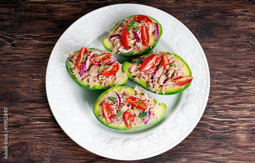 Avocado boats stuffed with tuna, red onion and cherry tomatoes.