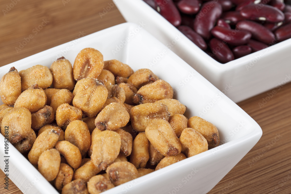 close-up image of roasted peanuts and kidney beans in background. close-up image of roasted peanuts and kidney beans in background.