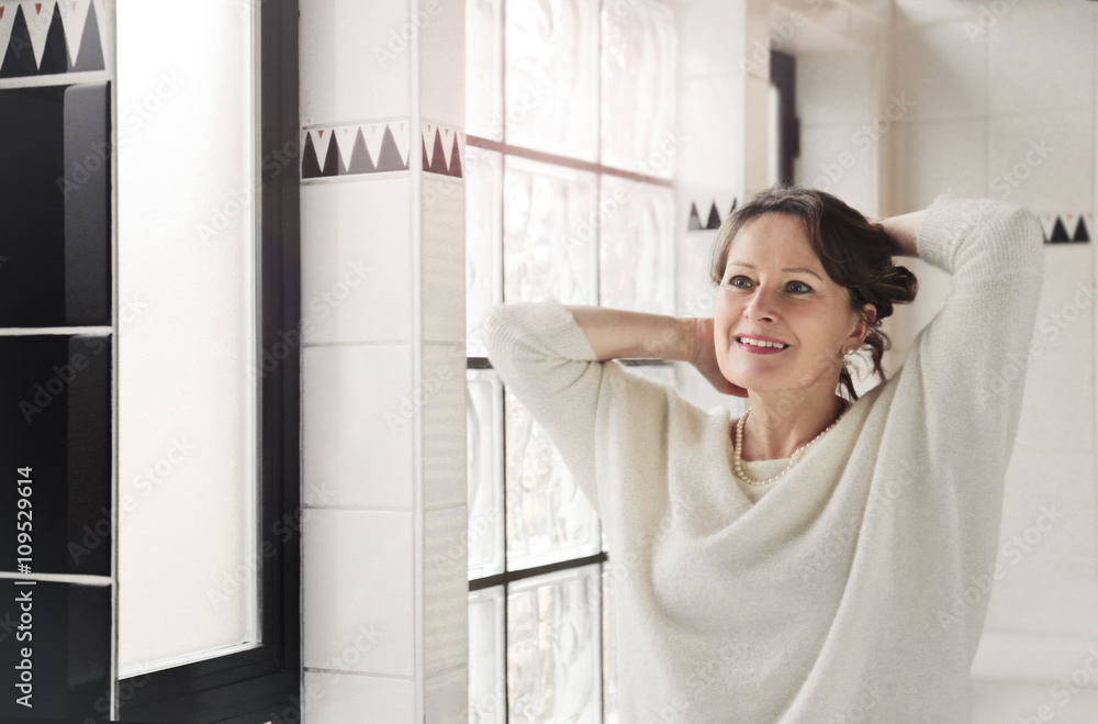 Beautiful woman looking herself at the mirror Beautiful woman looking herself at the mirror
